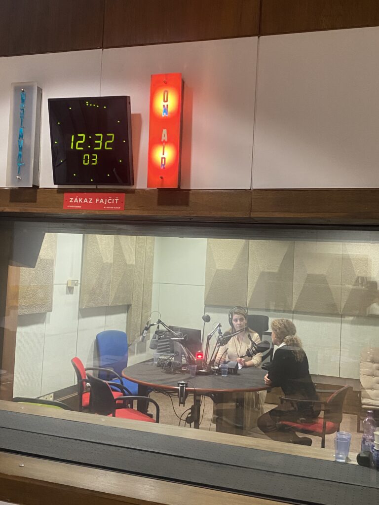 Radio studio with Cilla Benkö being interviewed by a presenter. 