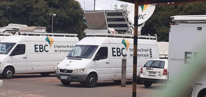 Two vans with EBC branding on them parked in a car park.