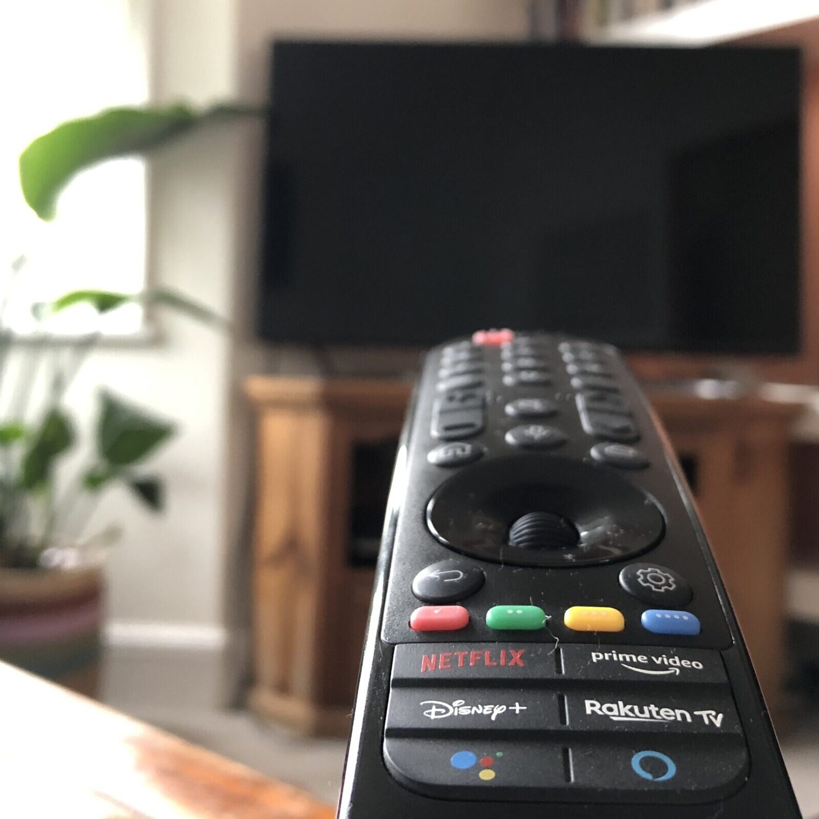 Remote control pointed at a television.