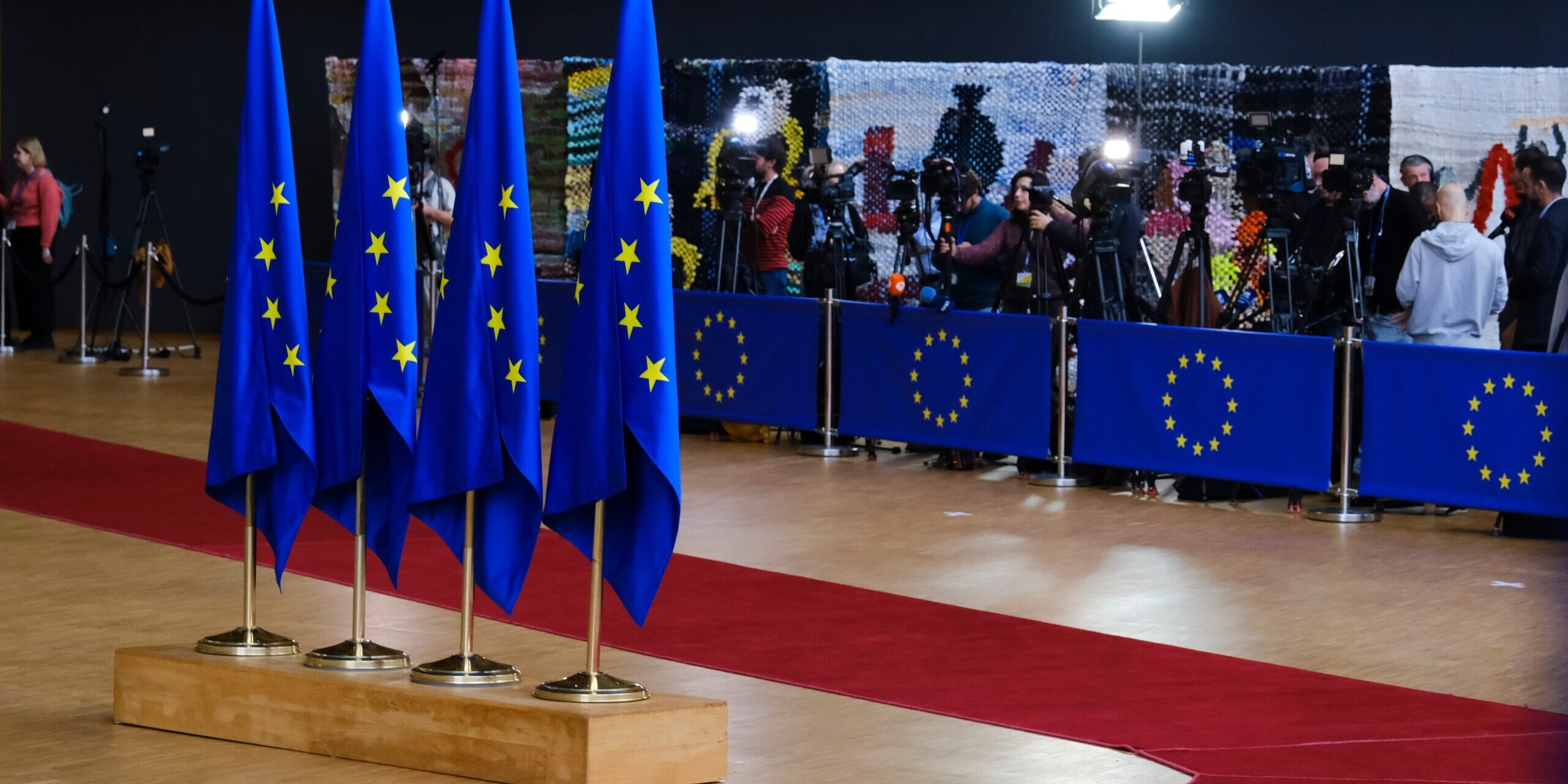 Row of EU flags with red carpet