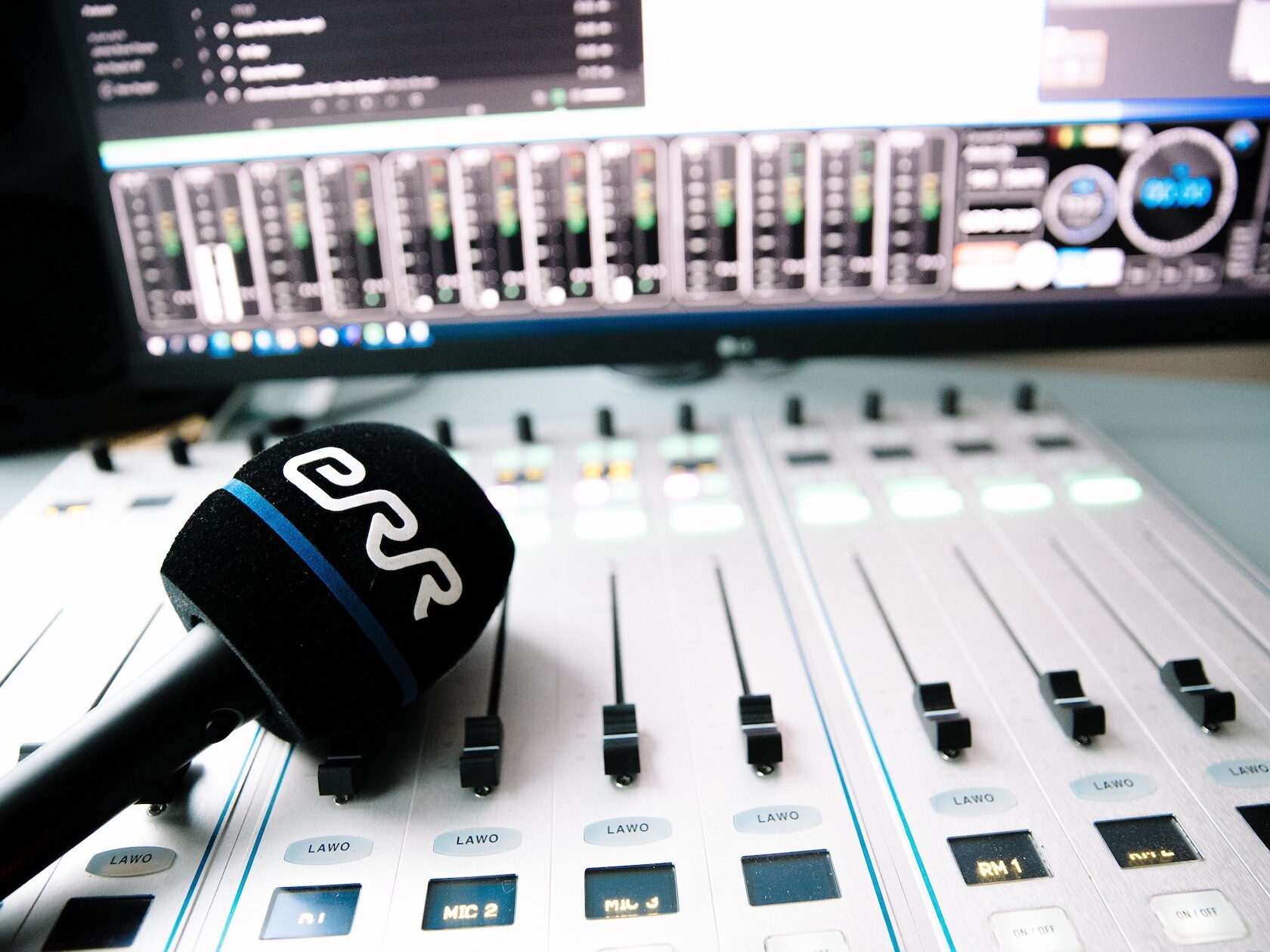 An ERR-branded microphone on a mixing desk.