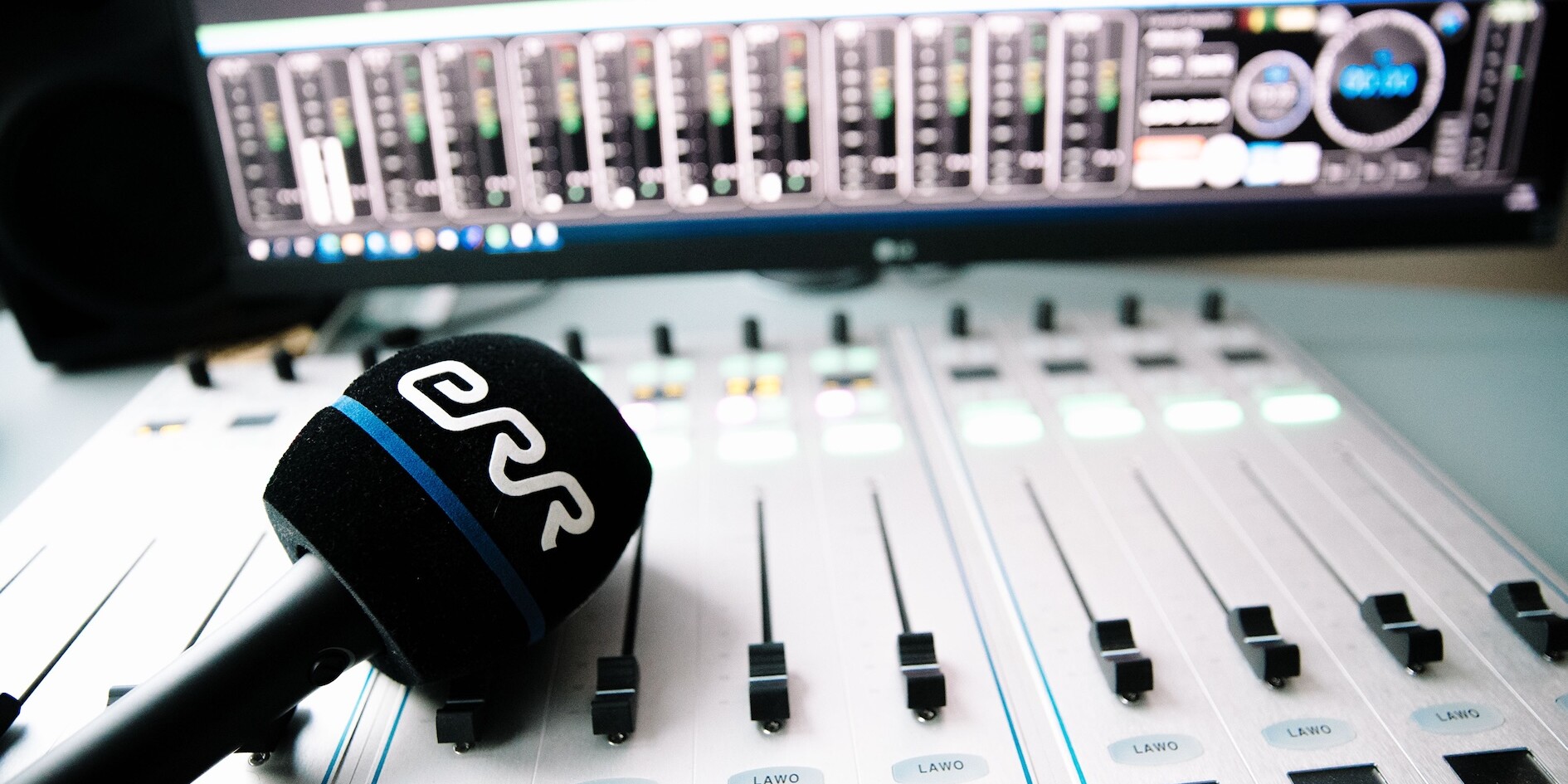 An ERR-branded microphone on a mixing desk.
